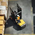 a man in a hard hat on a forklift