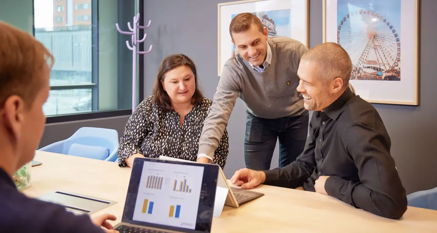 Proxio support - a group of people looking at a laptop